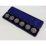 A good quality boxed set of six silver cast button