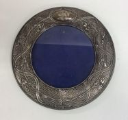 A stylish circular silver picture frame of texture