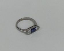 An unusual sapphire and diamond three stone cockta