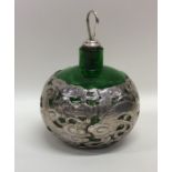 A stylish Chinese silver and green glass scent bot