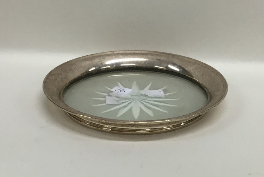 A silver and glass mounted coaster. Approx. 81.8 g