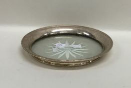 A silver and glass mounted coaster. Approx. 81.8 g