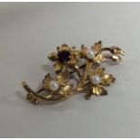 A 9 carat garnet and pearl brooch. Approx. 4.5 gra