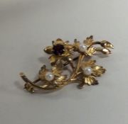 A 9 carat garnet and pearl brooch. Approx. 4.5 gra