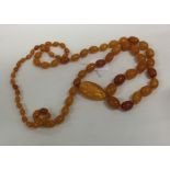 A tapering string of yellow amber beads with match