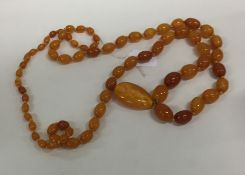 A tapering string of yellow amber beads with match