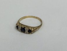 A sapphire and diamond seven stone ring in carved