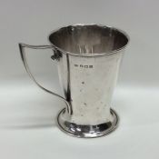 A stylish silver christening cup on spreading base