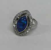 A black opal and diamond large cluster ring set in