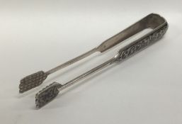 A pair of silver and Niello ice tongs decorated wi