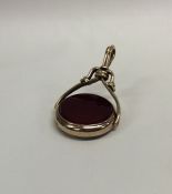 A blood stone set spinning fob with loop top. Appr