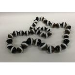 A large tapering string of banded agate beads. App