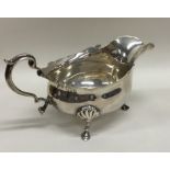 An Edwardian silver sauce boat with scroll feet. L
