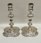 A good pair of cast silver candlesticks on spreadi