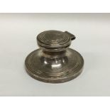 A silver hinged top inkwell with reeded decoration