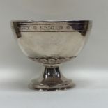 An Edwardian silver presentation bowl on spreading