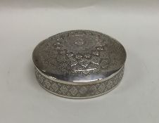 An Indian silver dome top box engraved with flower