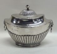 An Edwardian silver half fluted boat shaped tea ca