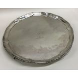 A Georgian silver salver of circular form with bea