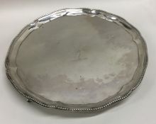 A Georgian silver salver of circular form with bea