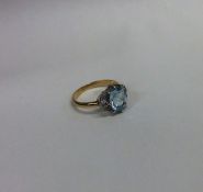 An aquamarine and diamond cluster ring in gold and