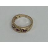 A ruby three stone ring. Approx. 4 grams. Est. £40