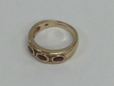 A ruby three stone ring. Approx. 4 grams. Est. £40