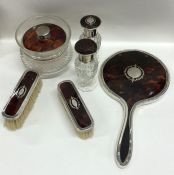 A good silver and tortoiseshell dressing table set