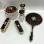 A good silver and tortoiseshell dressing table set