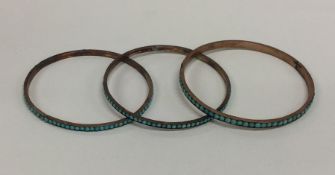 Three turquoise mounted slave bangles. Approx. 23