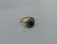 A circular sapphire and diamond cluster ring in 18