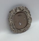 A Chinese silver oval picture frame decorated with