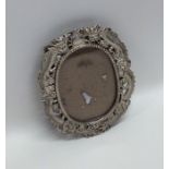 A Chinese silver oval picture frame decorated with