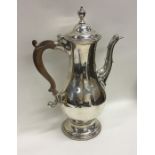 A Georgian silver coffee pot of baluster form and