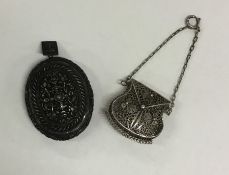 A Continental oval silver locket together with a m