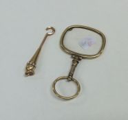 A small gold mounted button hook with pearl border