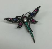 A massive brooch in the form of a dragonfly with o