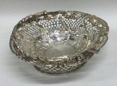 A small Georgian silver swing handled sweet basket