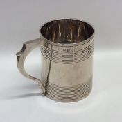 A Georgian silver half pint mug with fluted body.