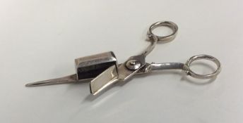 An unusual pair of Antique silver candle snuffers