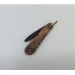 A small 9 carat fruit knife with loop top. Approx.