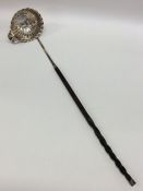 A good Georgian silver toddy ladle with swirl bowl