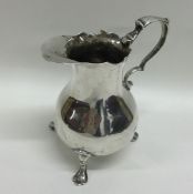 A plain George II helmet shaped silver cream jug w