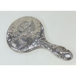 An embossed silver decorated hand mirror mounted w