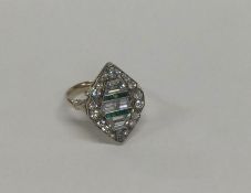 A large stylish emerald and diamond cocktail ring