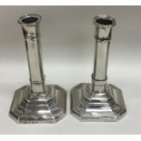 A pair of Edwardian silver candlesticks with reede