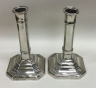 A pair of Edwardian silver candlesticks with reede