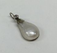 A silver and pearl pendant with loop top. Approx.