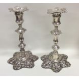 A pair of George II cast silver candlesticks on sh