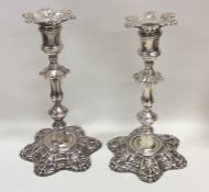 A pair of George II cast silver candlesticks on sh